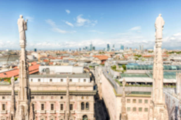 Defocused background with scenic aerial view over the city centre, as seen from the roof of the gothic Cathedral, Milan, Italy. Intentionally blurred post production for bokeh effect