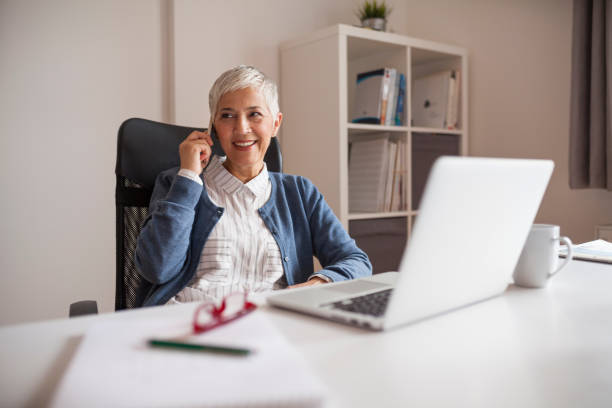 istock shoot of elderly woman working in her home office. 893095874