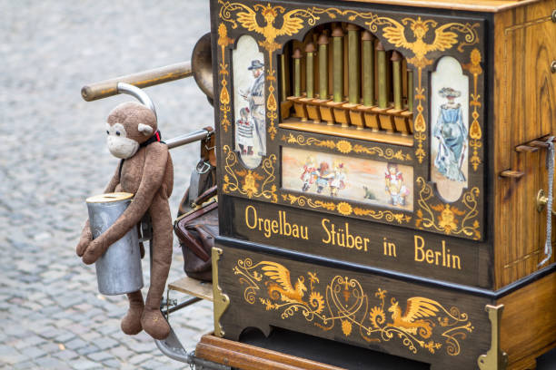 Old barrel organ with the monkey toy, Berlin Vintage Old barrel organ on the street, Berlin, Germany hurdy gurdy stock pictures, royalty-free photos & images