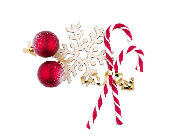 istock Lollipops lie vertically next to a snowflake on a white isolated background 893099106