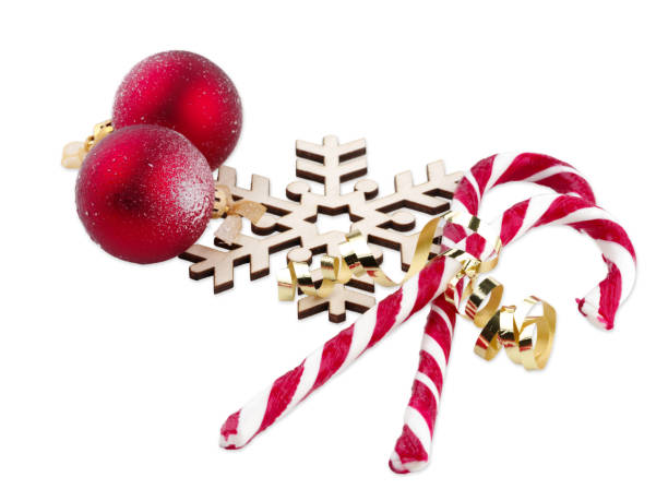 istock Lollipops lie next to a snowflake on a white isolated background 893101408