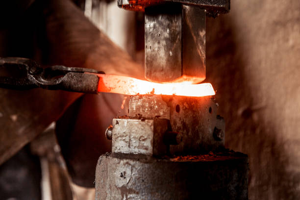 istock Blacksmith Working Hot Piece Of Metal On Forging Hammer 893102664