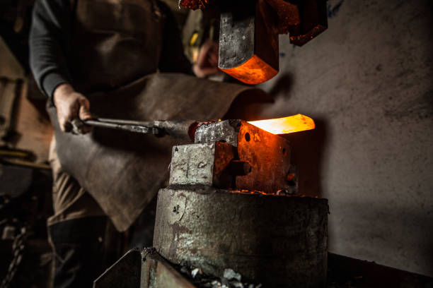 istock Blacksmith Working Hot Piece Of Metal On Forging Hammer 893102696