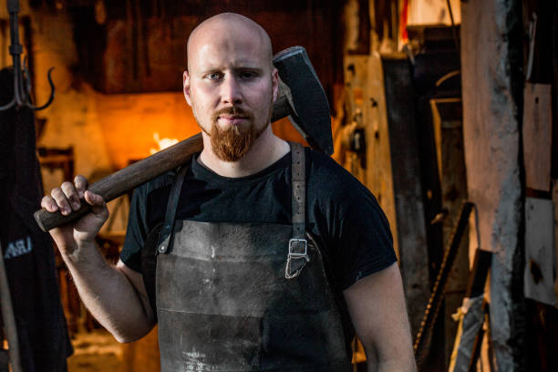 istock Portrait Of Young Blacksmith Holding Hammer 893102768