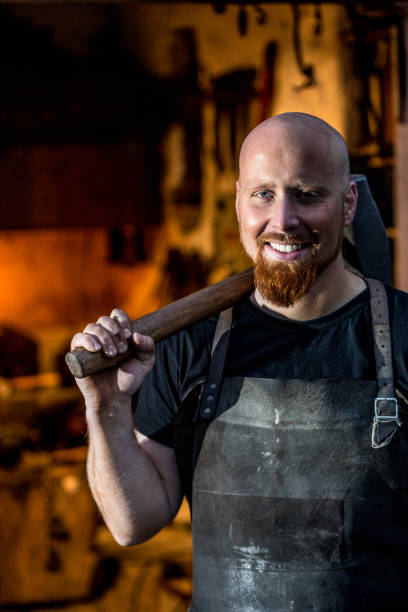 istock Portrait Of Young Blacksmith Holding Hammer 893102838