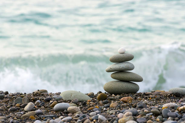 istock Stones pyramid on Black sea beach symbolizing stability, zen, harmony, balance. 893107808