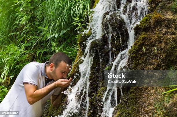 Enjoying In Nature Stock Photo - Download Image Now - Drinking, Men, Spring - Flowing Water