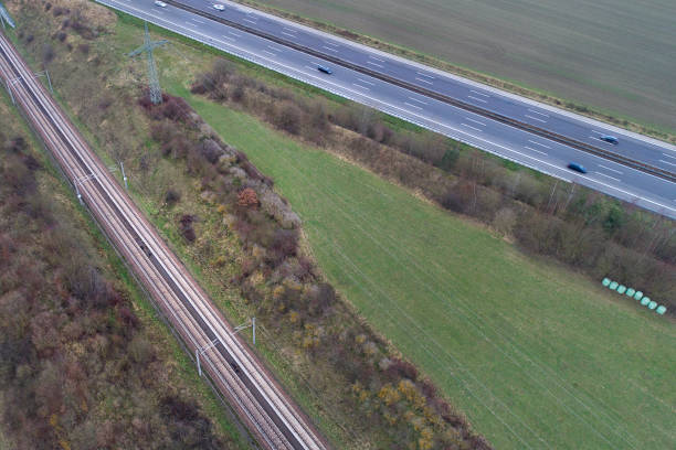 istock Railroad track and highway - aerial view 893126502