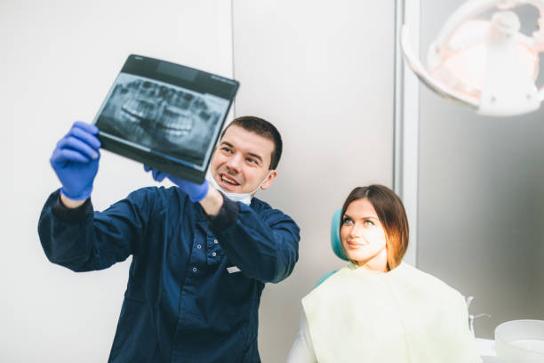 istock Dentist showing x-ray to a patient 893133328