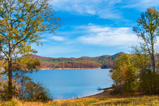 Autumn season at lake with beautiful forest at hill shore. stock photo