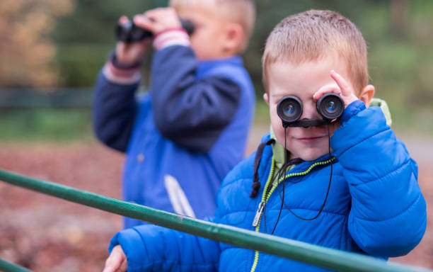 istock Boys enjoying in the forest with binoculars 893136008