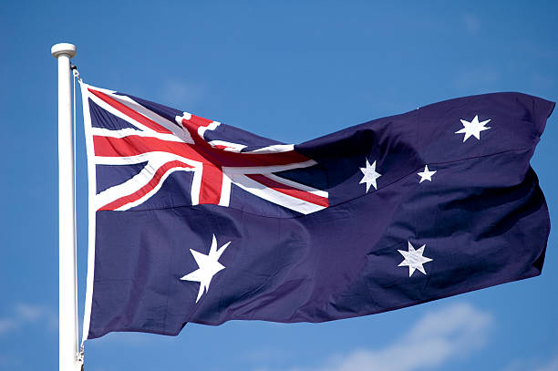 The Australian flag waving in the breeze stock photo