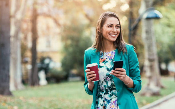 istock Woman texting in the park 893160680