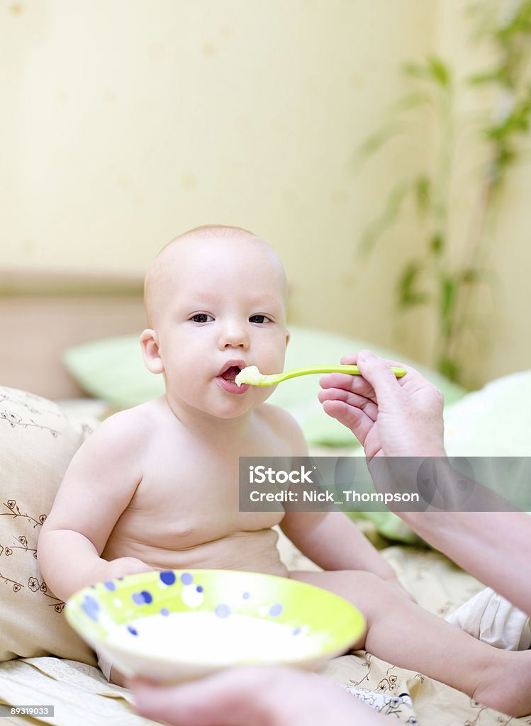 Mother feed baby by porridge #2  Baby - Human Age Stock Photo