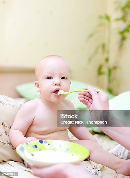 Mother Feed Baby By Porridge 2 Stock Photo - Download Image Now - Baby - Human Age, Baby Food, Bed - Furniture