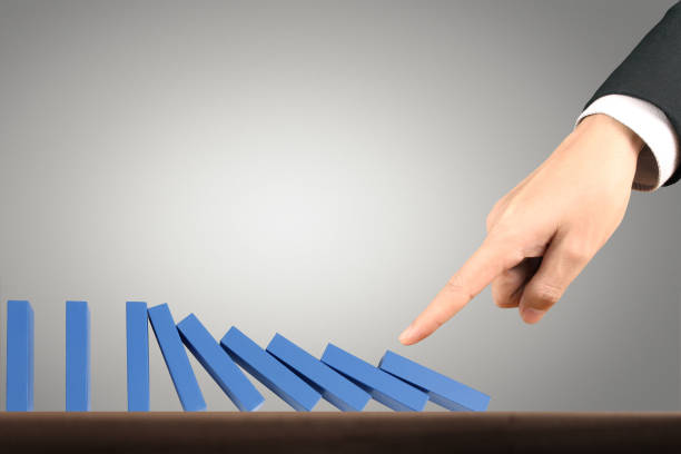 istock Hand Stopping domino concept 893196402