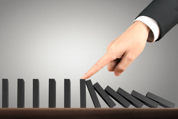 istock Hand Stopping domino concept 893196406