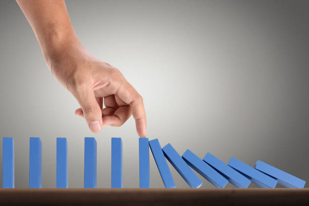 istock Hand Stopping domino concept 893196408