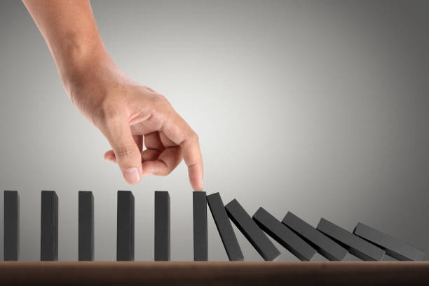 istock Hand Stopping domino concept 893196410