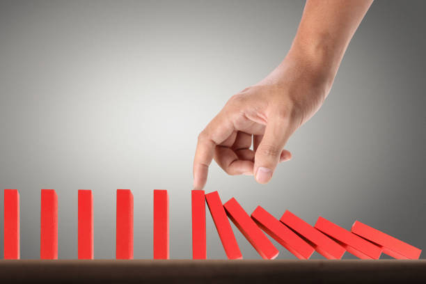 istock Hand Stopping domino concept 893196420