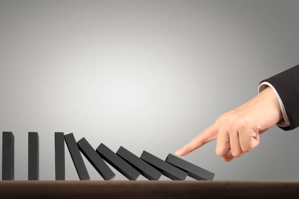 istock Hand Stopping domino concept 893196434