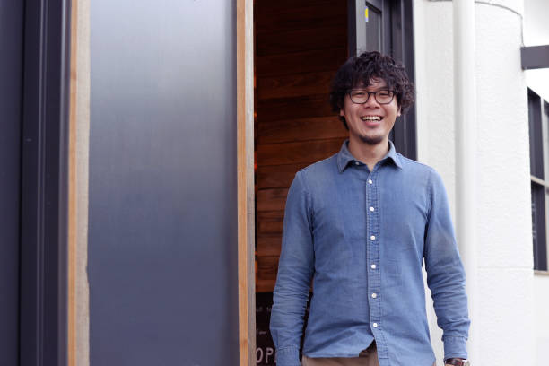 istock Cafe owner standing at the entrance 893217688