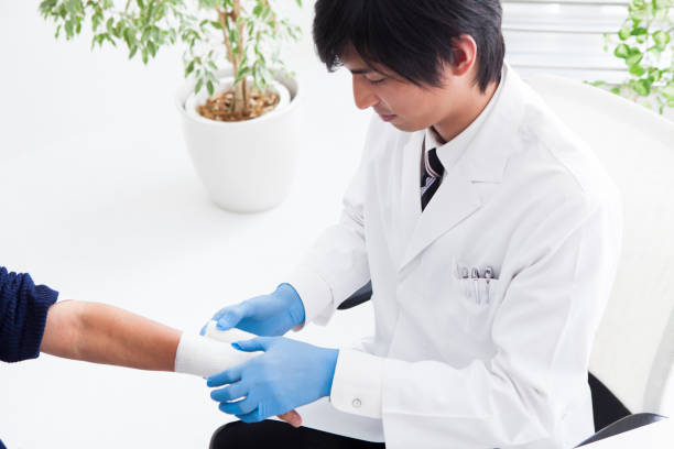 istock A doctor is wrapping a bandage around the patient's arm. 893220398