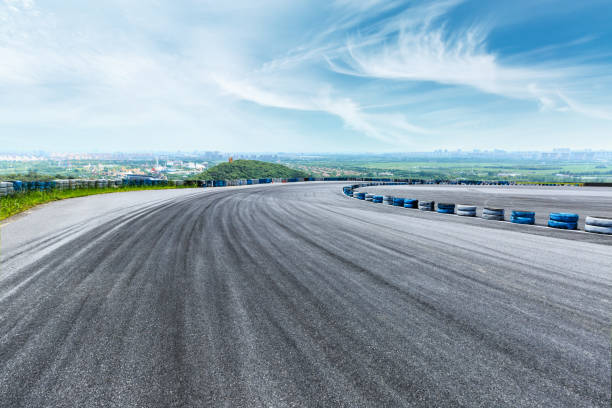 istock International circuit asphalt road and blue sky landscape 893252610