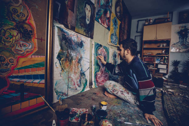 istock Artist working on a painting in studio 893257158