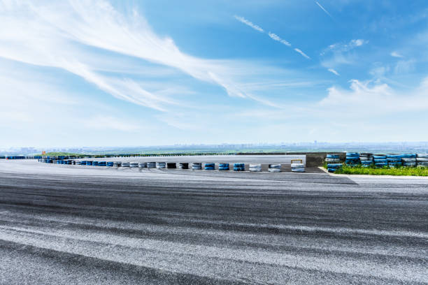 istock International circuit asphalt road and blue sky landscape 893259318