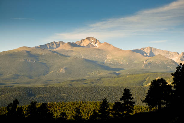 Long's Peak at Sunrise Longs Peak was named in honor of explorer Stephen Harriman Long and is featured on the Colorado state quarter. At 14,259 feet above sea level, the mountain can be seen from a wide area. This photograph of Longs Peak at sunrise was taken from Trail Ridge Road in Rocky Mountain National Park, Colorado, USA. jeff goulden rocky mountain national park stock pictures, royalty-free photos & images