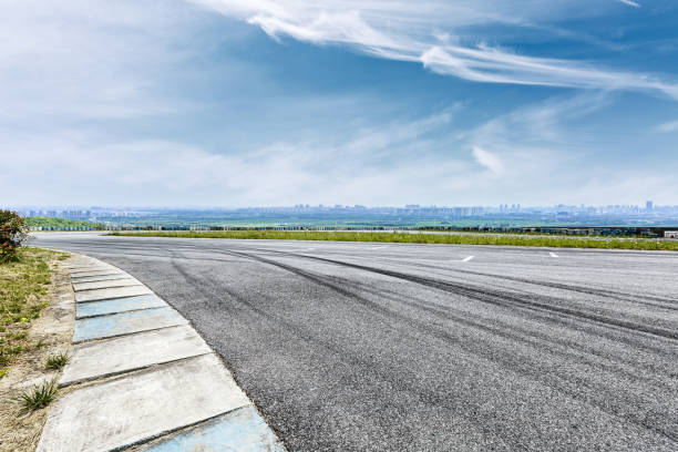 istock International circuit asphalt road and blue sky landscape 893259542