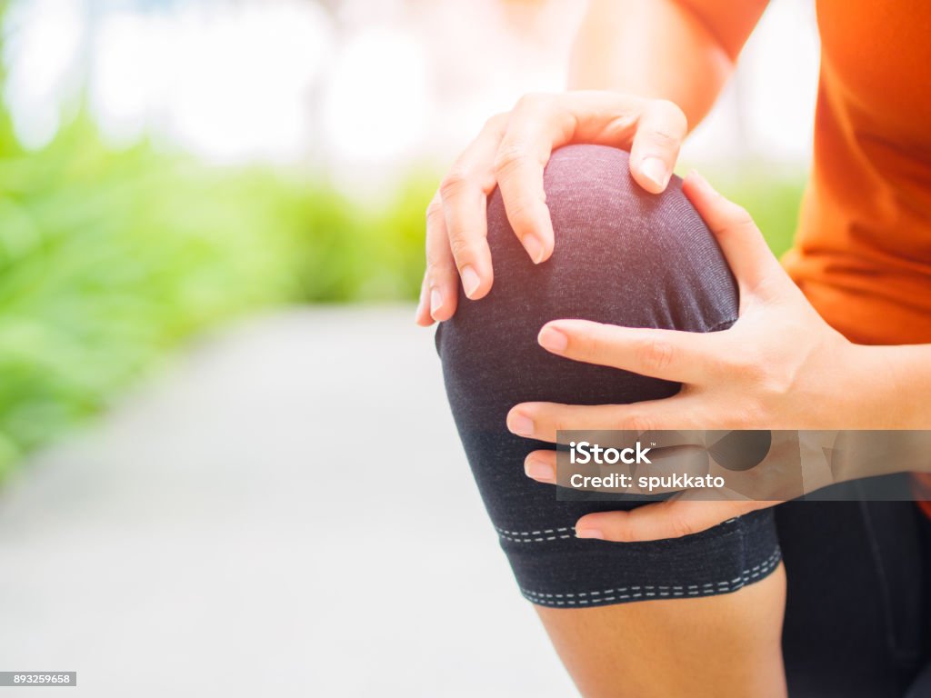 Blessure au genou de Runner sport. Femme dans la douleur lors de l’exécution dans le jardin. - Photo de Genou libre de droits