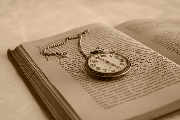 istock antique book and silver pocket watch 89326498