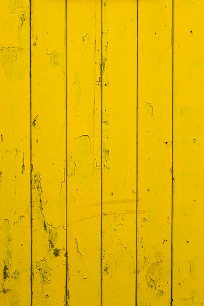 Dirty wooden Fence painted yellow stock photo