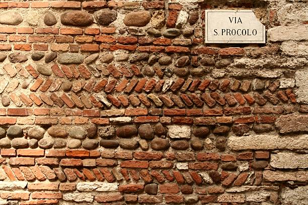 Woman walking on Castelvecchio Bridge. The bridge is part of the Castelvecchio (english: \