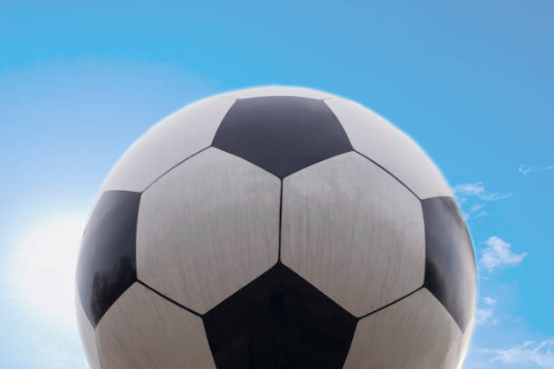 istock soccer ball and sky background. 893270434