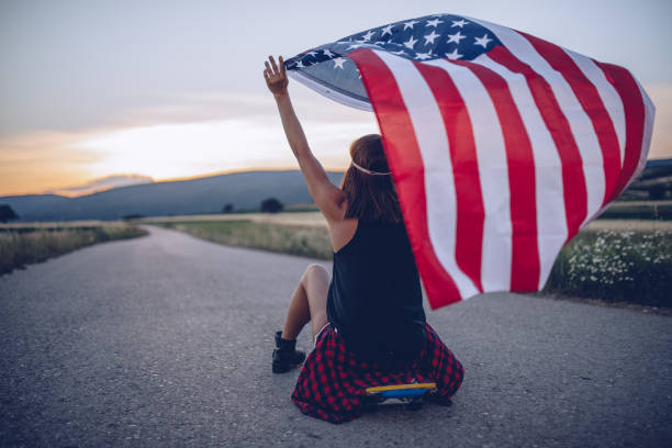 istock Young woman with an American flag 893272286