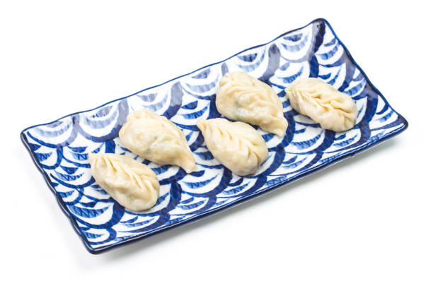 istock Fresh boiled dumpling on plate. Chinese food with hot steams on background. 893272512