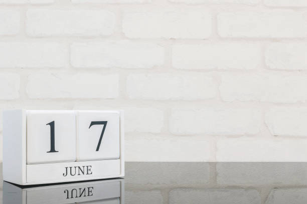 Closeup white wooden calendar with black 17 june word on black glass table and white brick wall textured background with copy space , selective focus at the calendar Closeup white wooden calendar with black 17 june word on black glass table and white brick wall textured background with copy space , selective focus at the calendar number 17 stock pictures, royalty-free photos & images