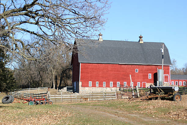 istock A red barn with a fence and a tractor outside. 89327408
