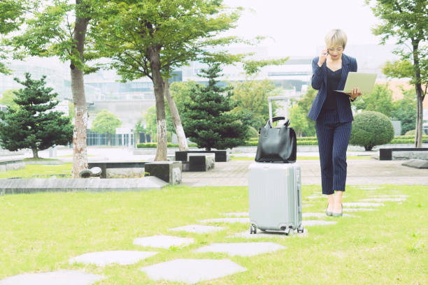 istock businesswoman multitasking outdoors 893282800