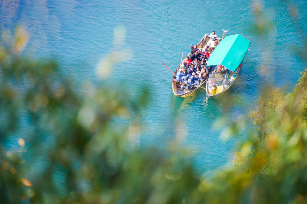 Kyoto, Japan - November 17, 2017 :Tourists enjoying a riverside view while riding on the river at Arashiyama, Kyoto, Japan
