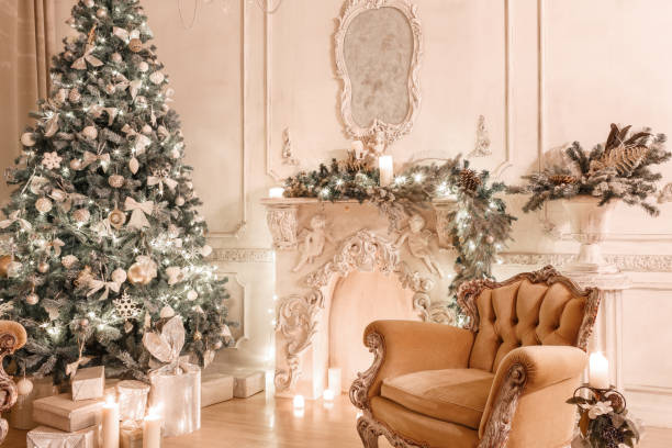 istock Christmas evening by candlelight. classic apartments with a white fireplace, decorated tree, sofa, large windows and chandelier. 893294148