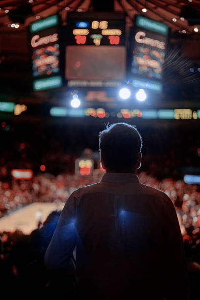 Backlit Man Watching Sporting Event - New York City stock photo