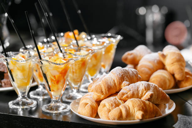 istock Fresh pastry, crispy morning croissants, hotel breakfast buffet. Dessert fruit cocktail in cups 893307748
