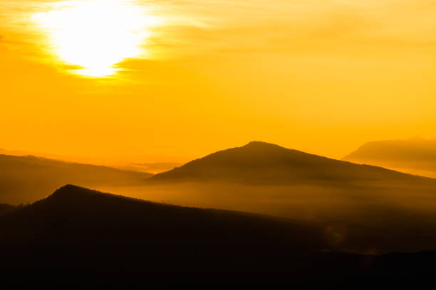 istock colorful sunrise in the mountain. Silhouette background. 893308306