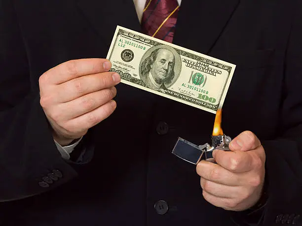 Photo of Man burnning the money