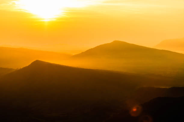 istock colorful sunrise in the mountain. Silhouette background. 893311486