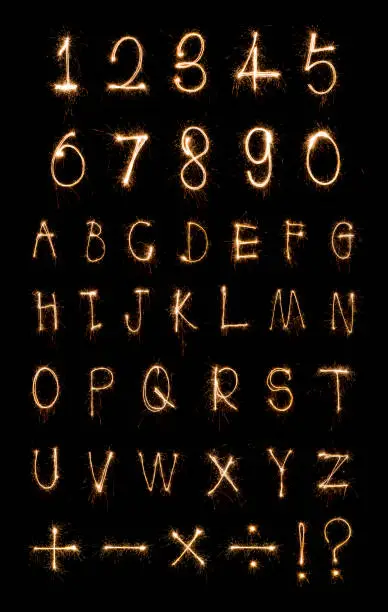 Photo of Alphabet and Numbers sparklers on black background